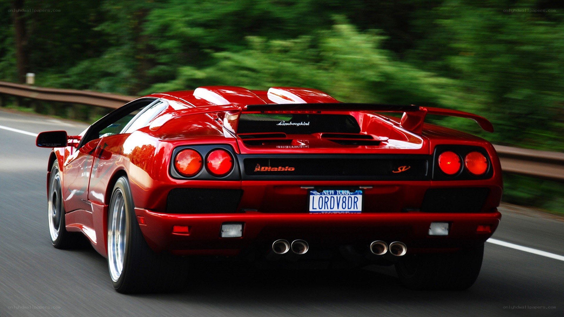 Red Lamborghini Diablo driving on road