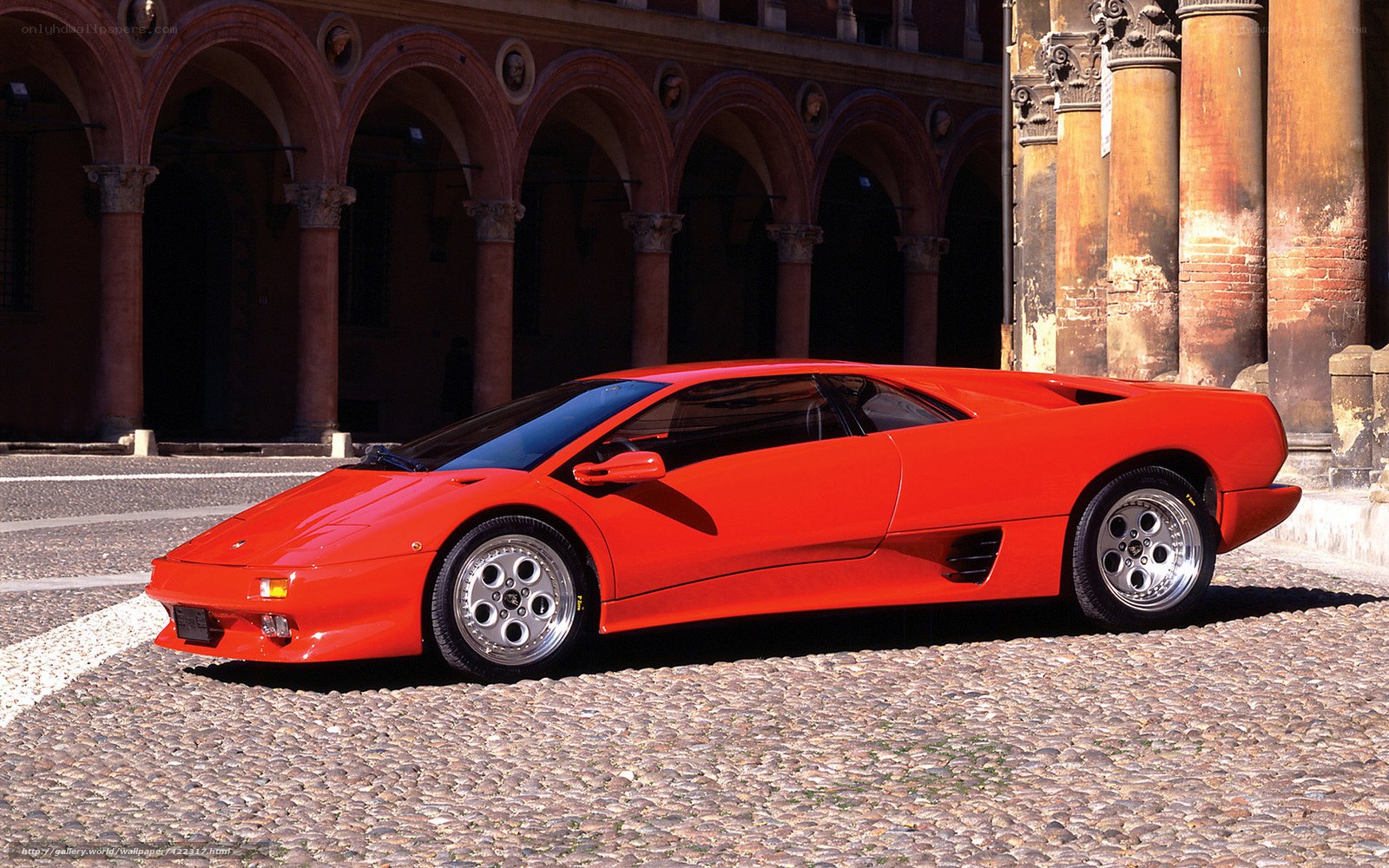 Red Lamborghini Diablo on cobblestones