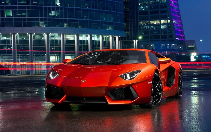 Red Lamborghini in city at night