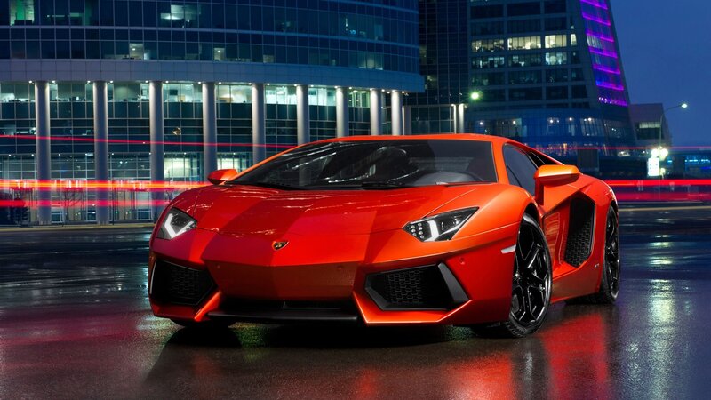 Red Lamborghini in city at night