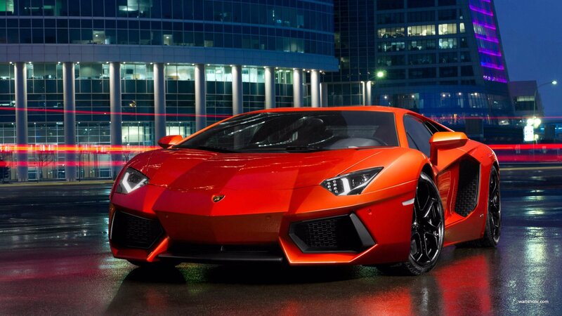 Red Lamborghini in city at night