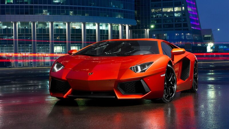 Red Lamborghini in city at night