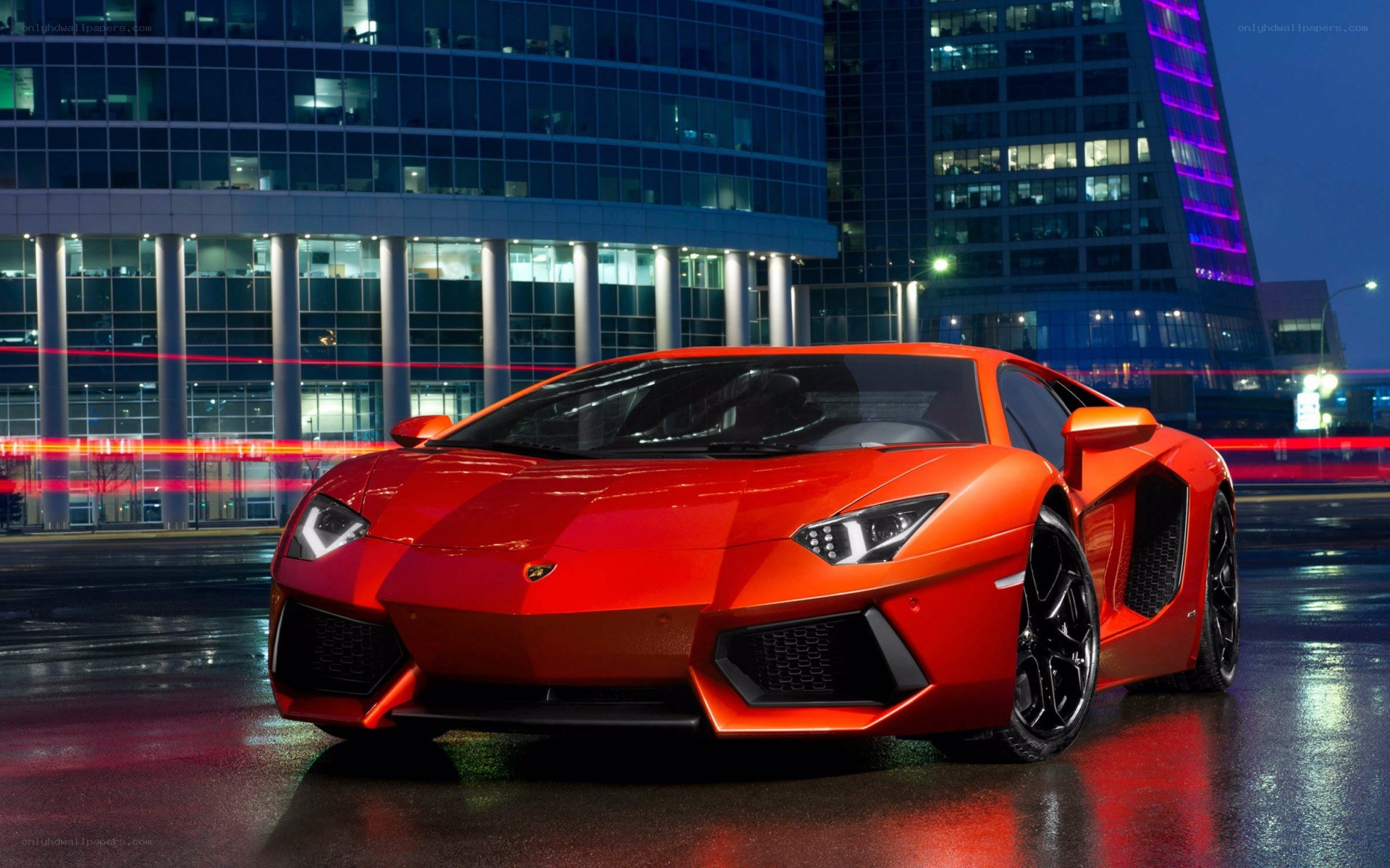 Red Lamborghini in city at night