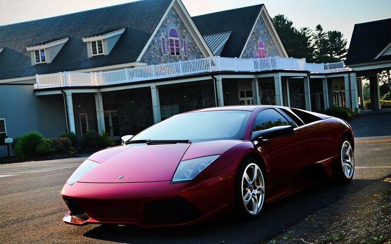 Red Lamborghini in front of a house