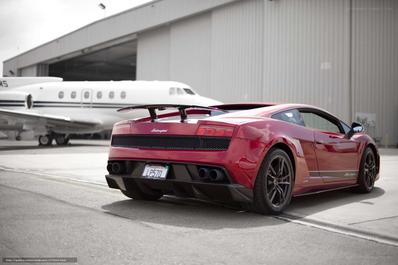 Red Lamborghini in front of a private jet