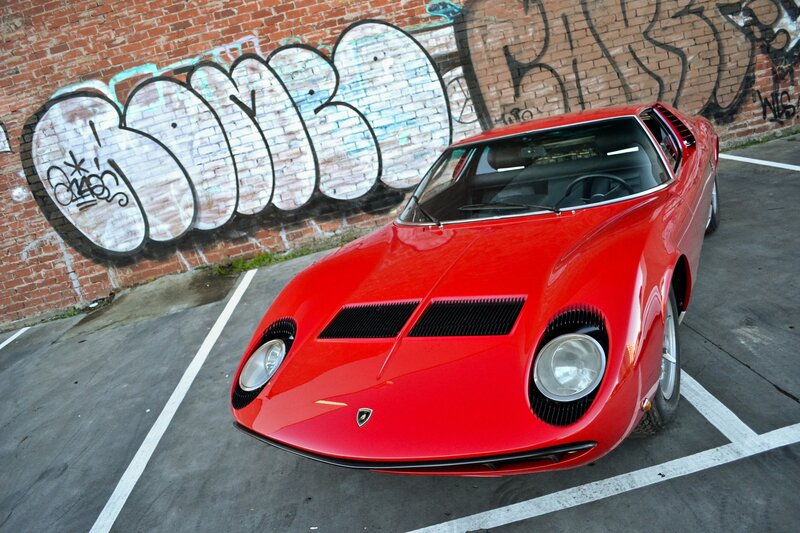 Red Lamborghini Miura in parking lot