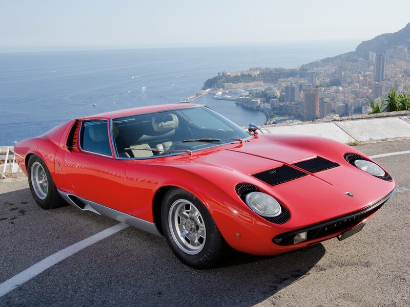 Red Lamborghini Miura on coastal road