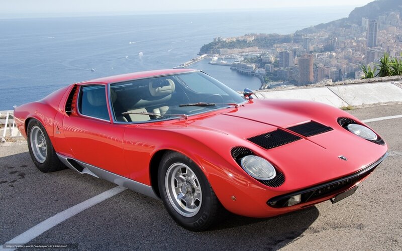 Red Lamborghini Miura on coastal road
