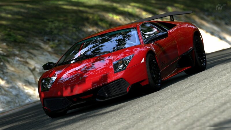 red lamborghini on a winding road