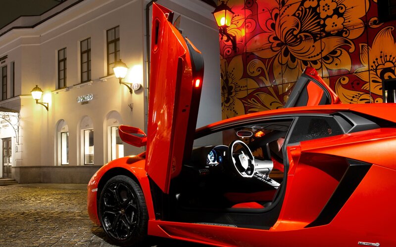 Red Lamborghini on cobblestone street