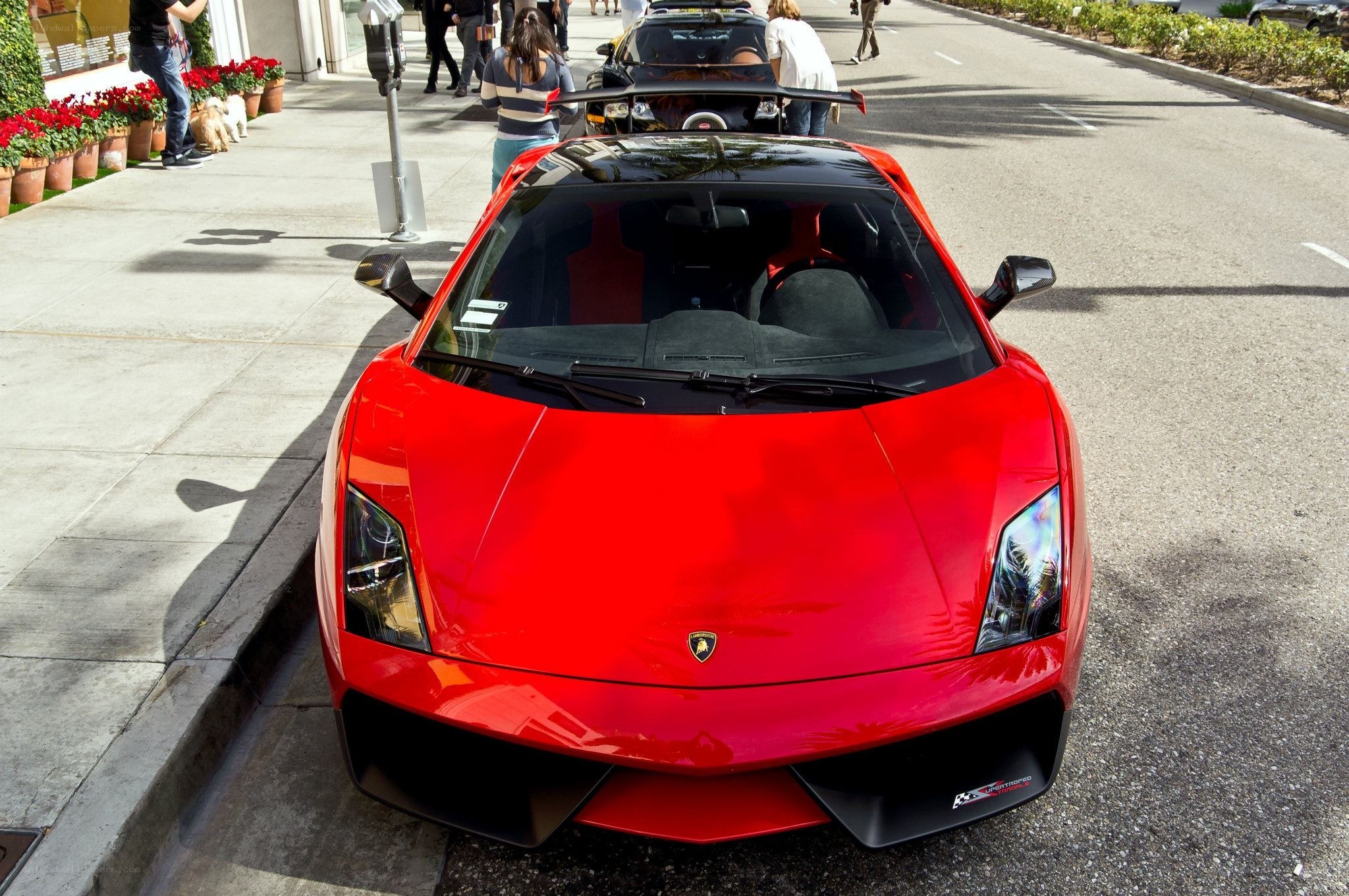 Red Lamborghini parked on street