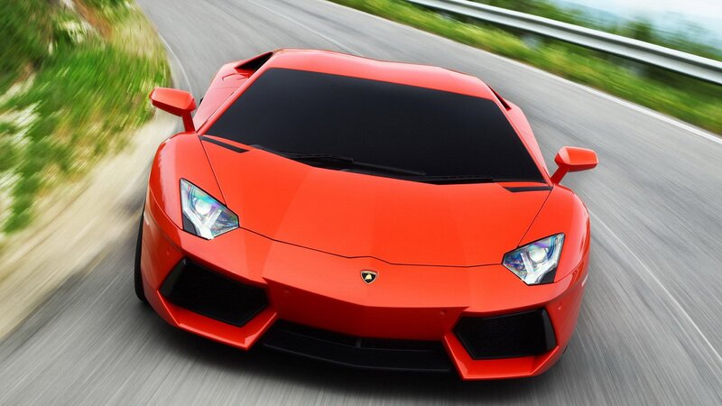 Red Lamborghini speeding on road