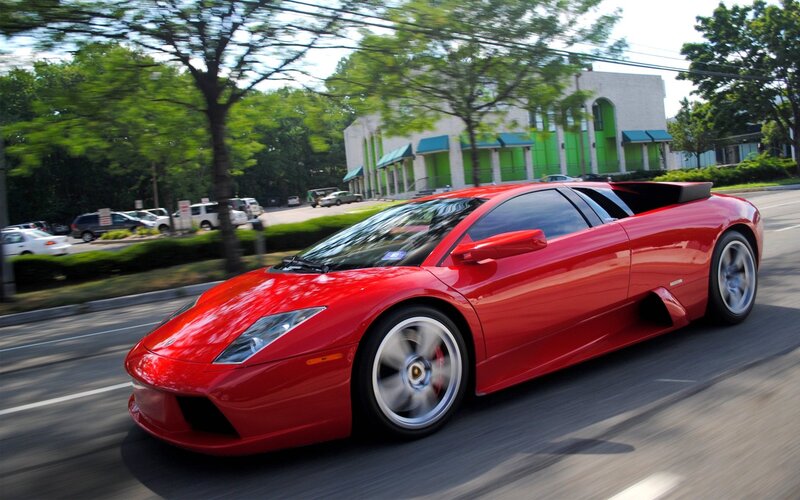 Red Lamborghini sports car in motion