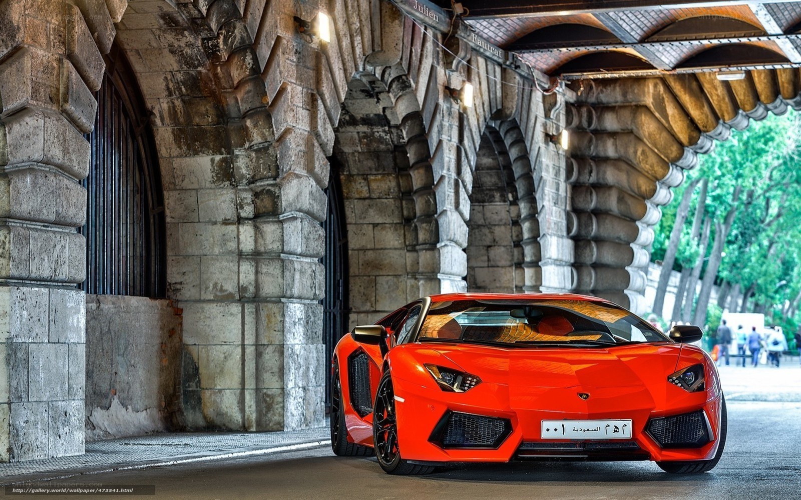 Red Lamborghini under stone arches