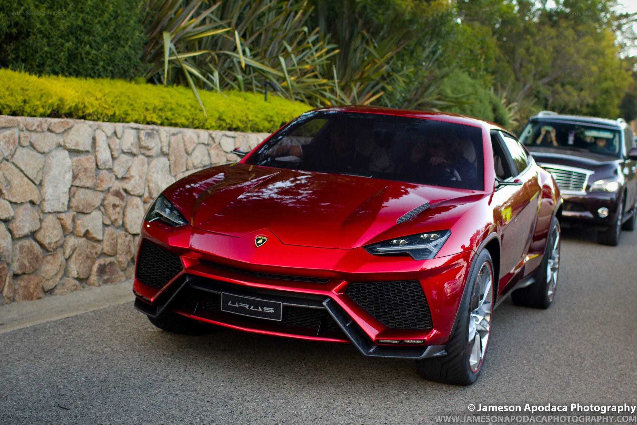 Red Lamborghini Urus on a road