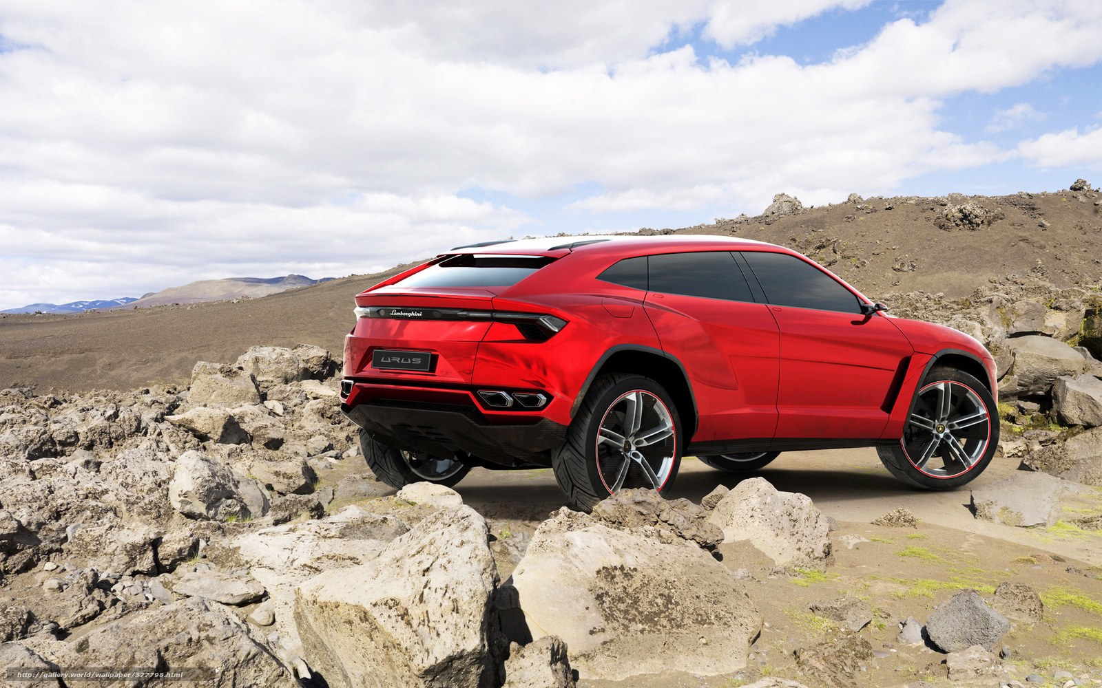 Red Lamborghini Urus on rocky terrain