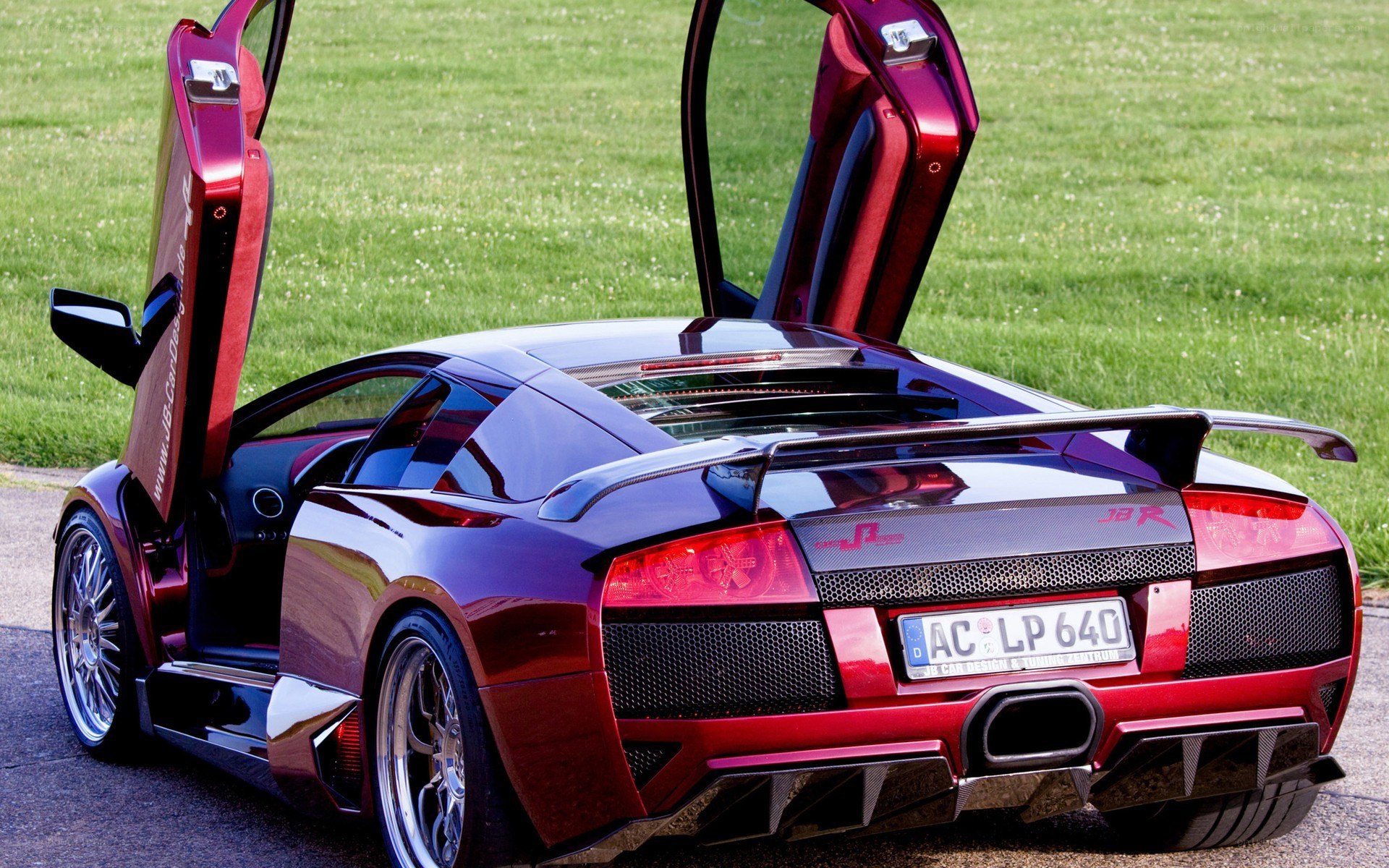 red lamborghini with doors open