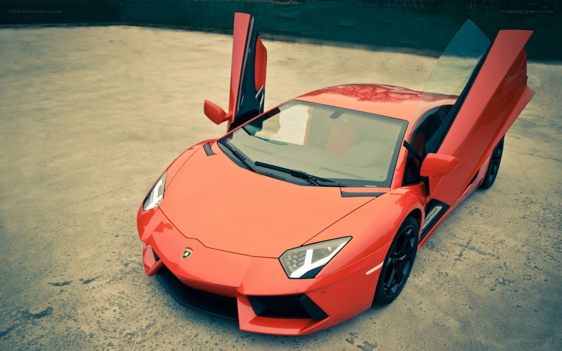 red lamborghini with doors open