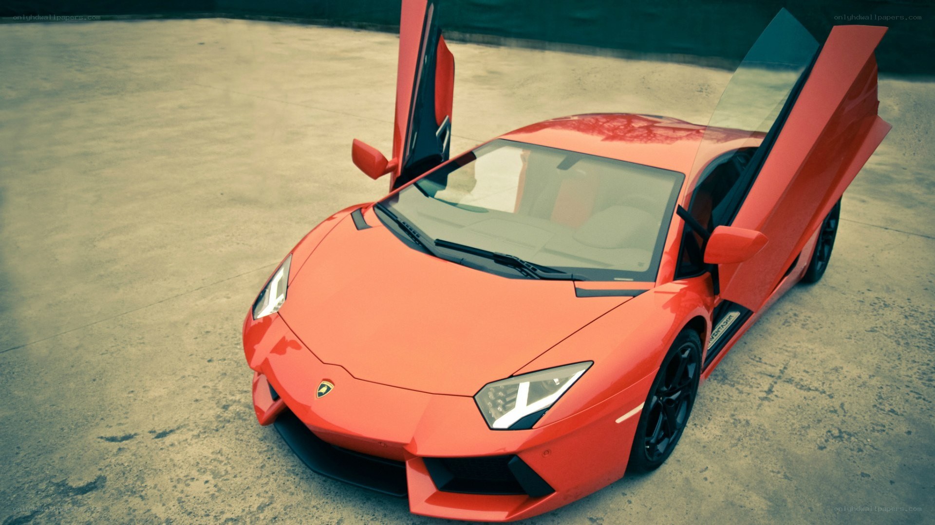 red lamborghini with doors open