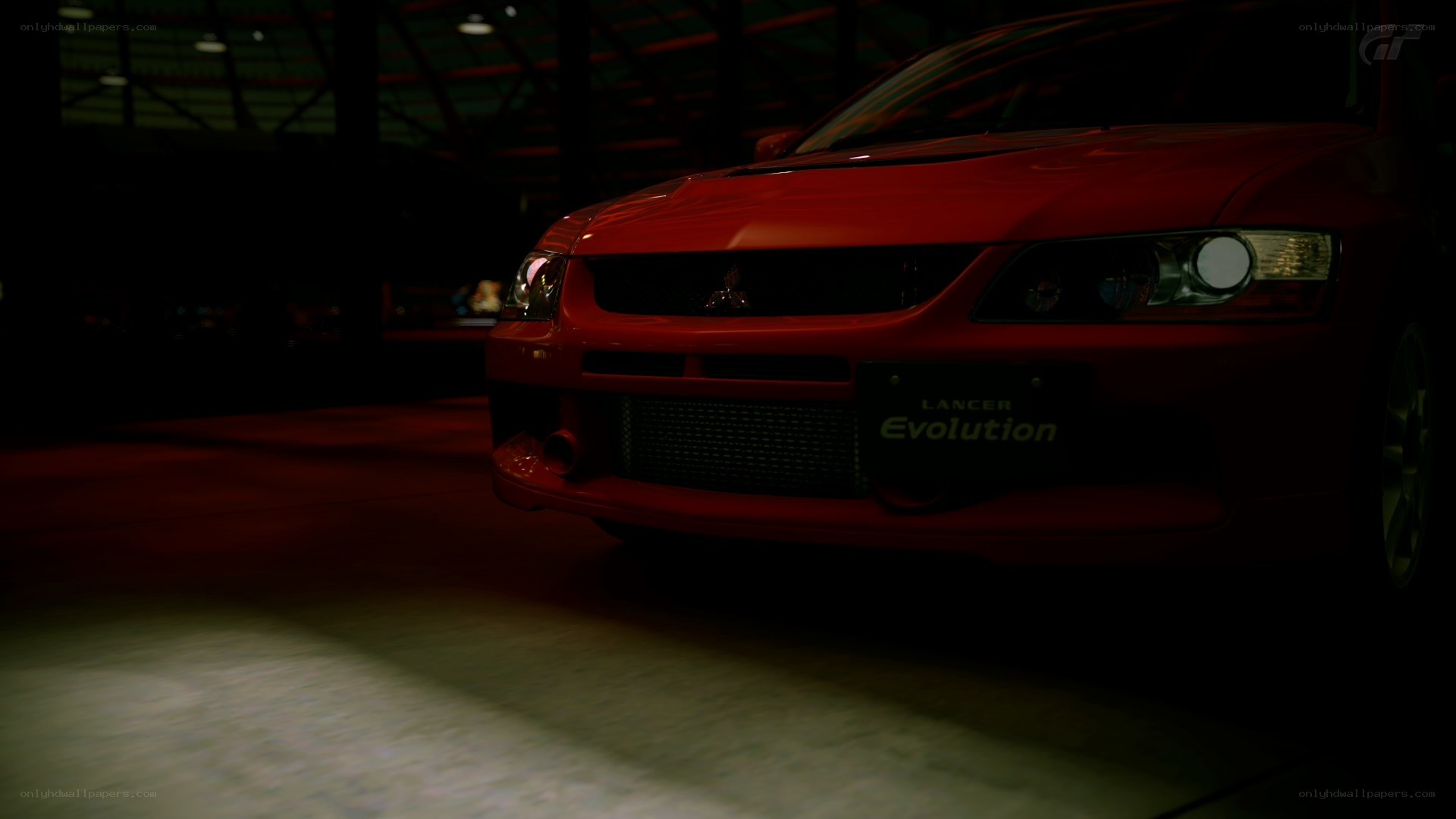 Red Lancer Evolution in dark garage