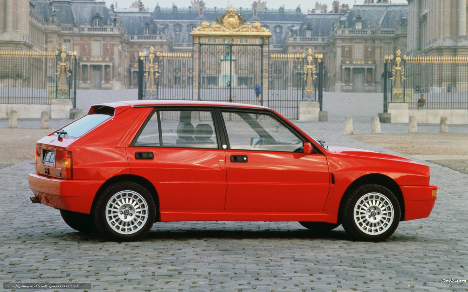 Red Lancia Delta in front of palace