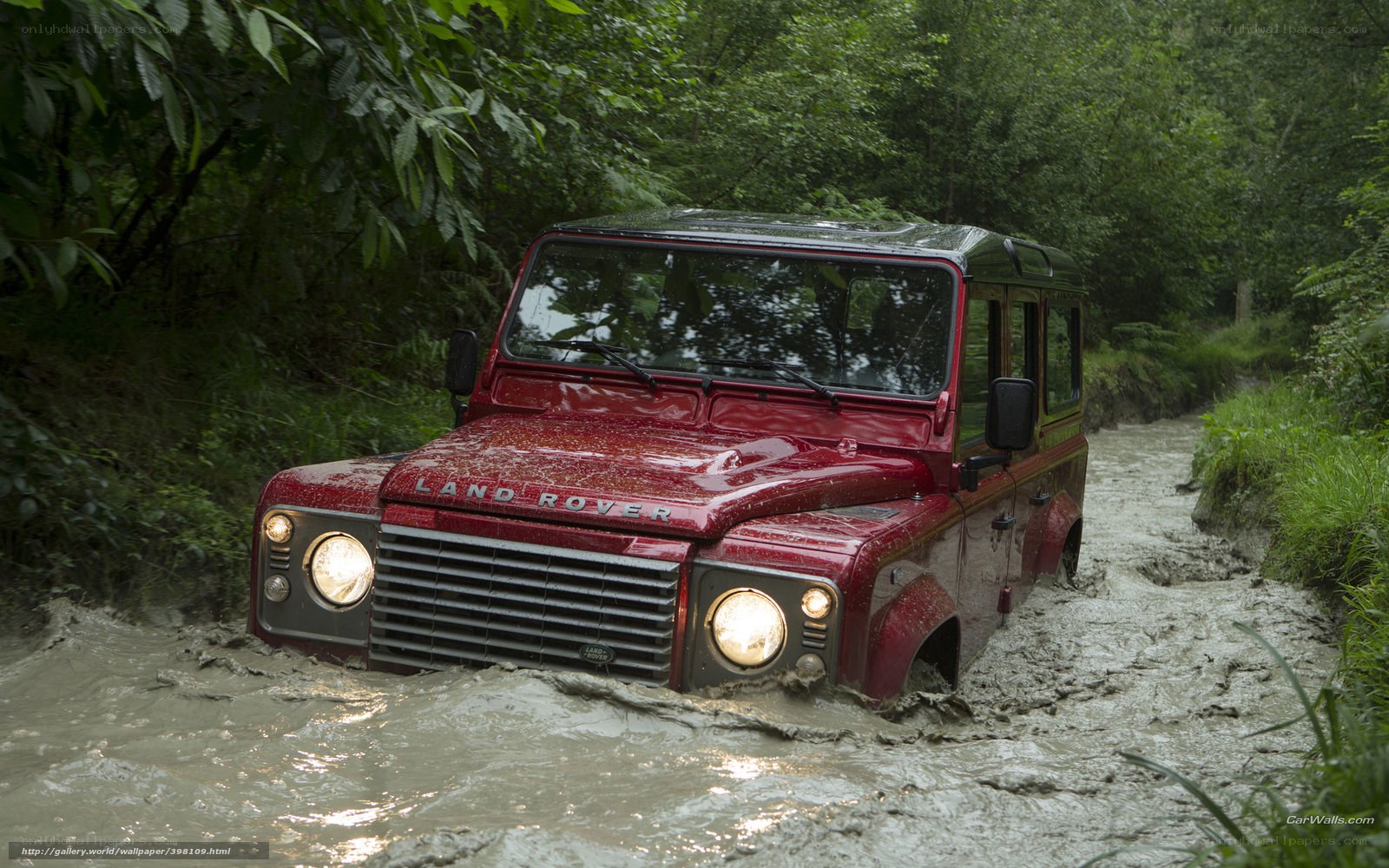 red land rover in mud