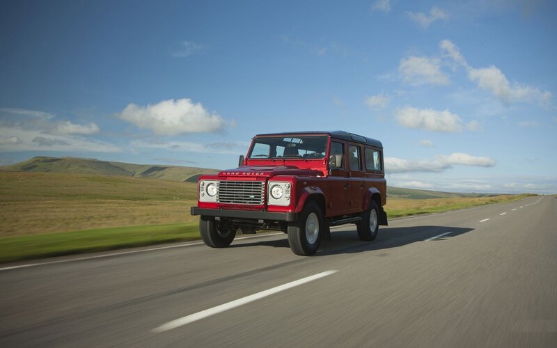 Red Land Rover on a country road