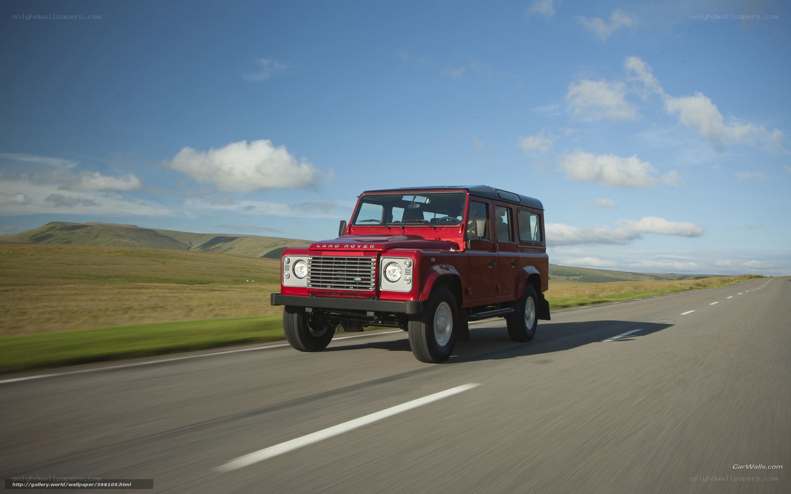 Red Land Rover on a country road