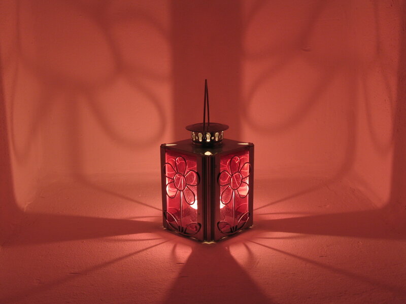 Red lantern casting floral shadows