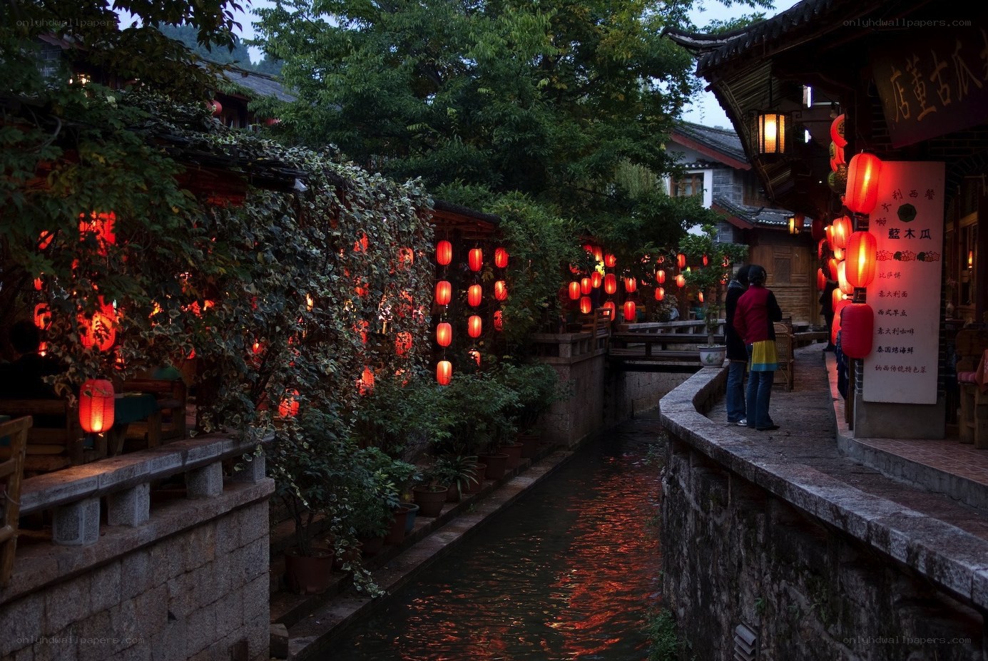 Red lanterns on a canal at dusk
