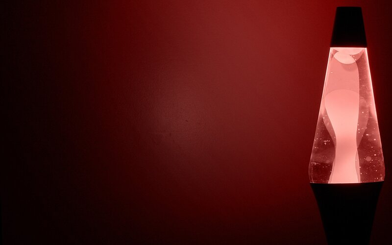Red lava lamp on dark background