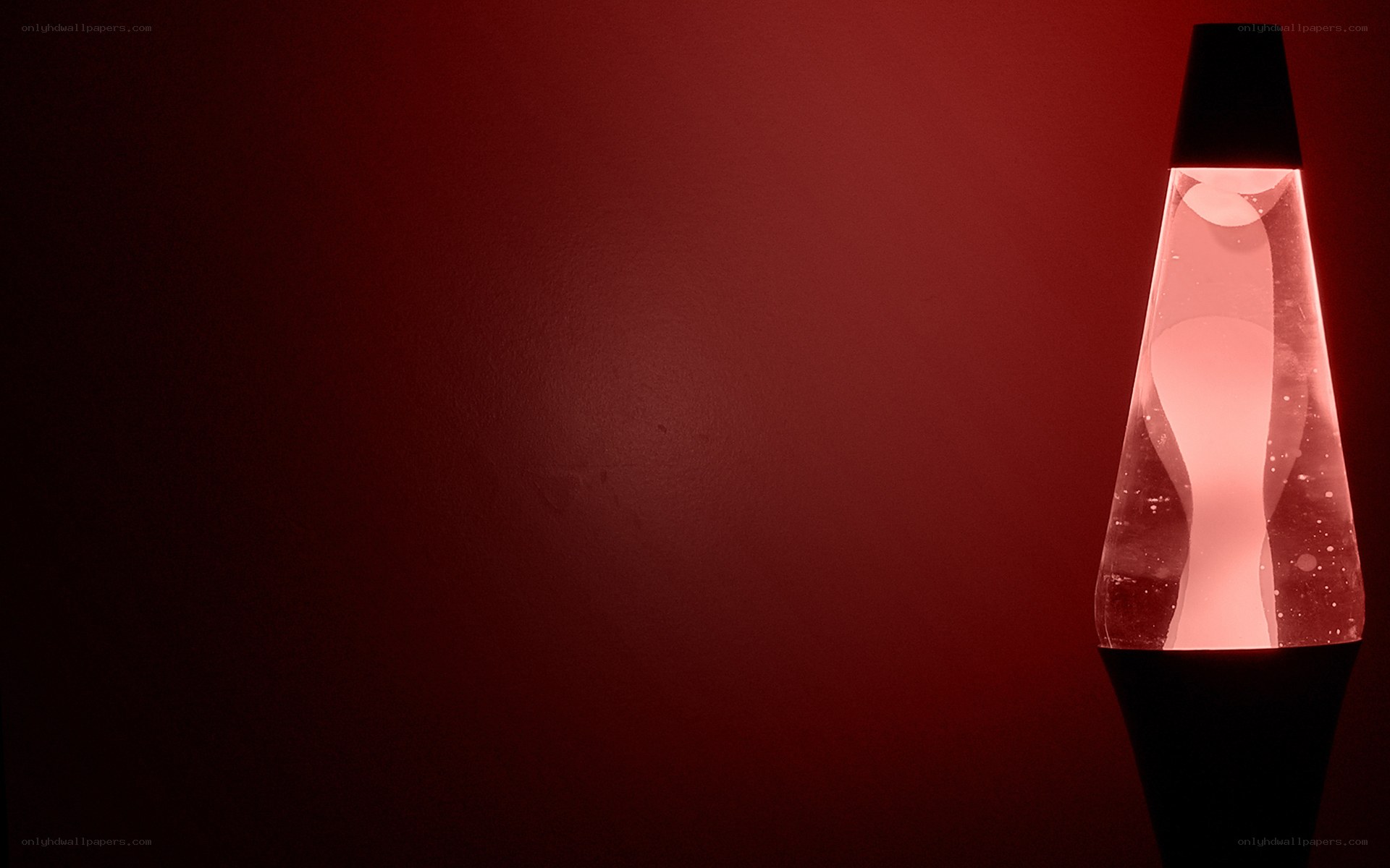 Red lava lamp on dark background