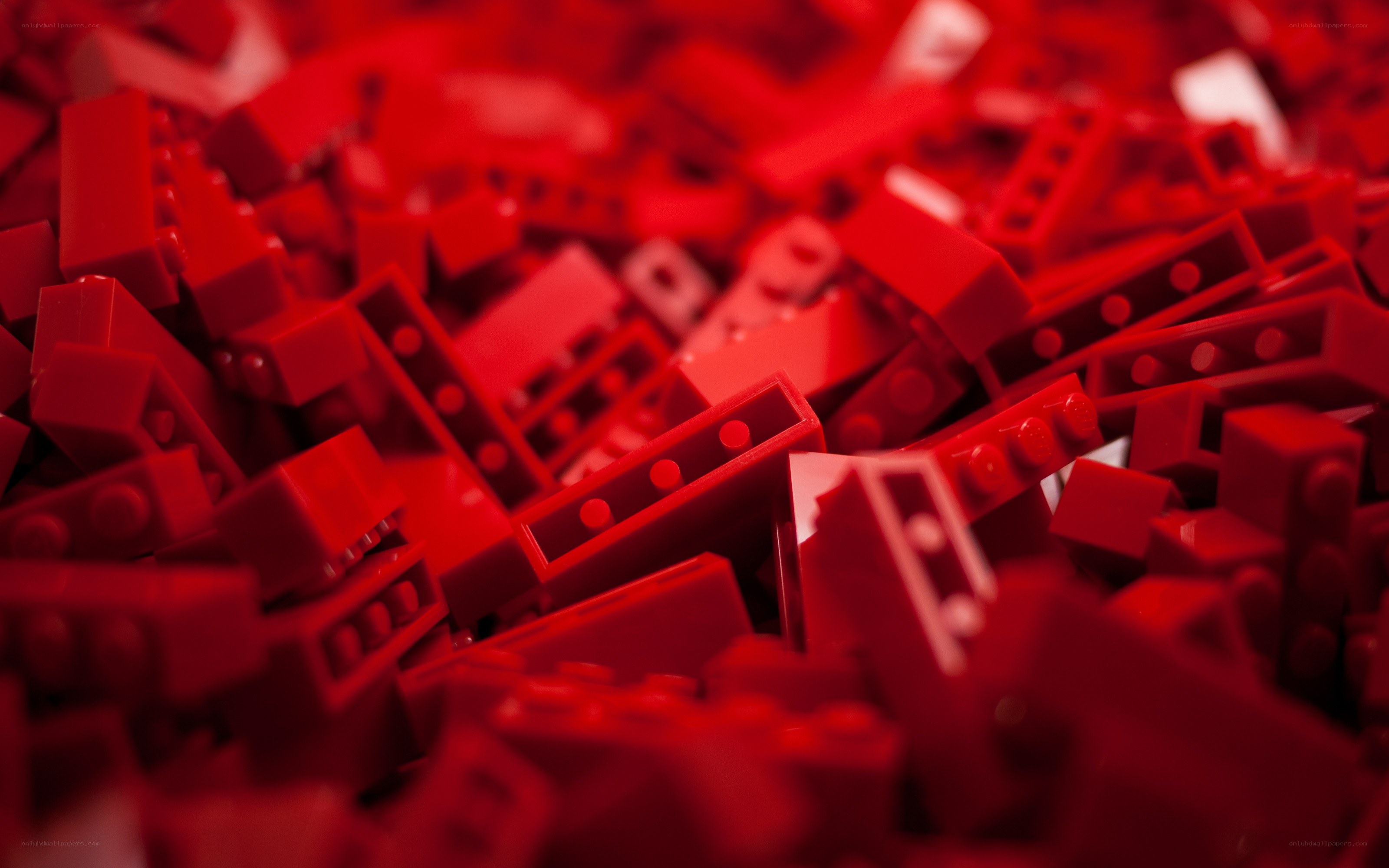 Red LEGO bricks in a pile