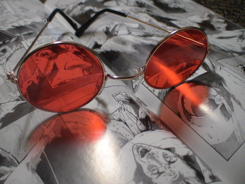 red-lensed sunglasses on comic book