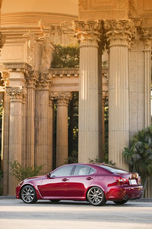 Red Lexus IS sedan in front of classical building