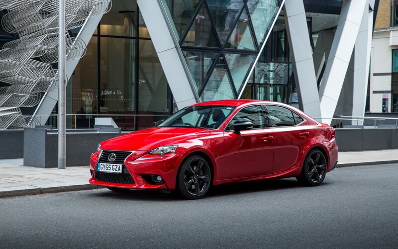 Red Lexus IS sedan on city street