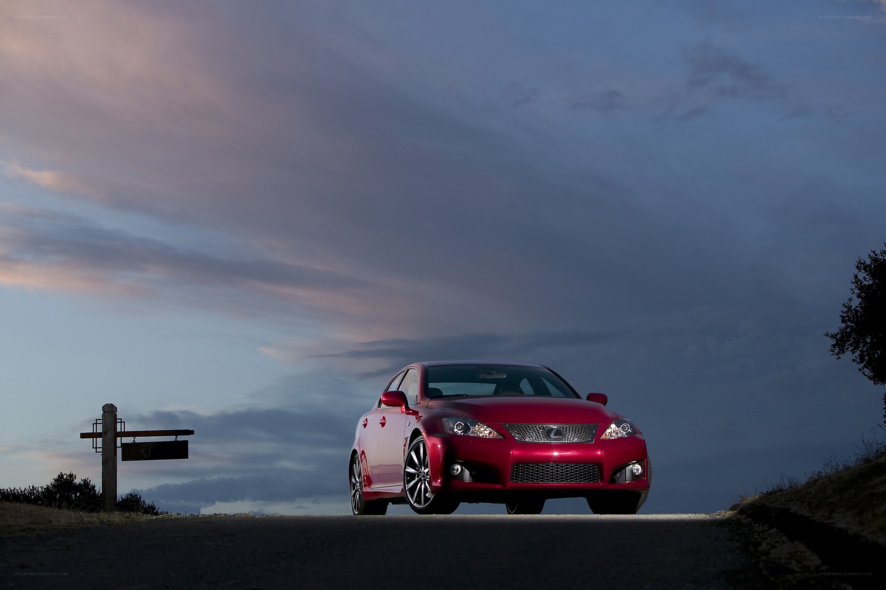 Red Lexus on a road at dusk