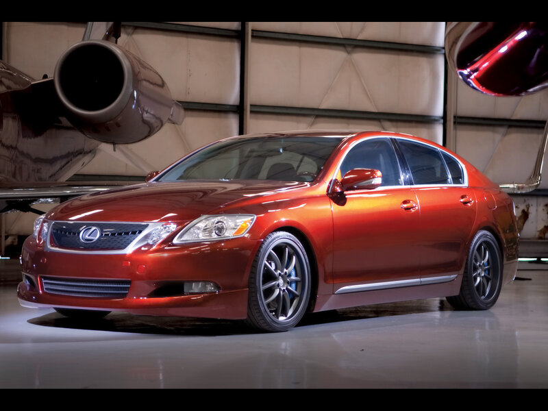 Red Lexus sedan in hangar