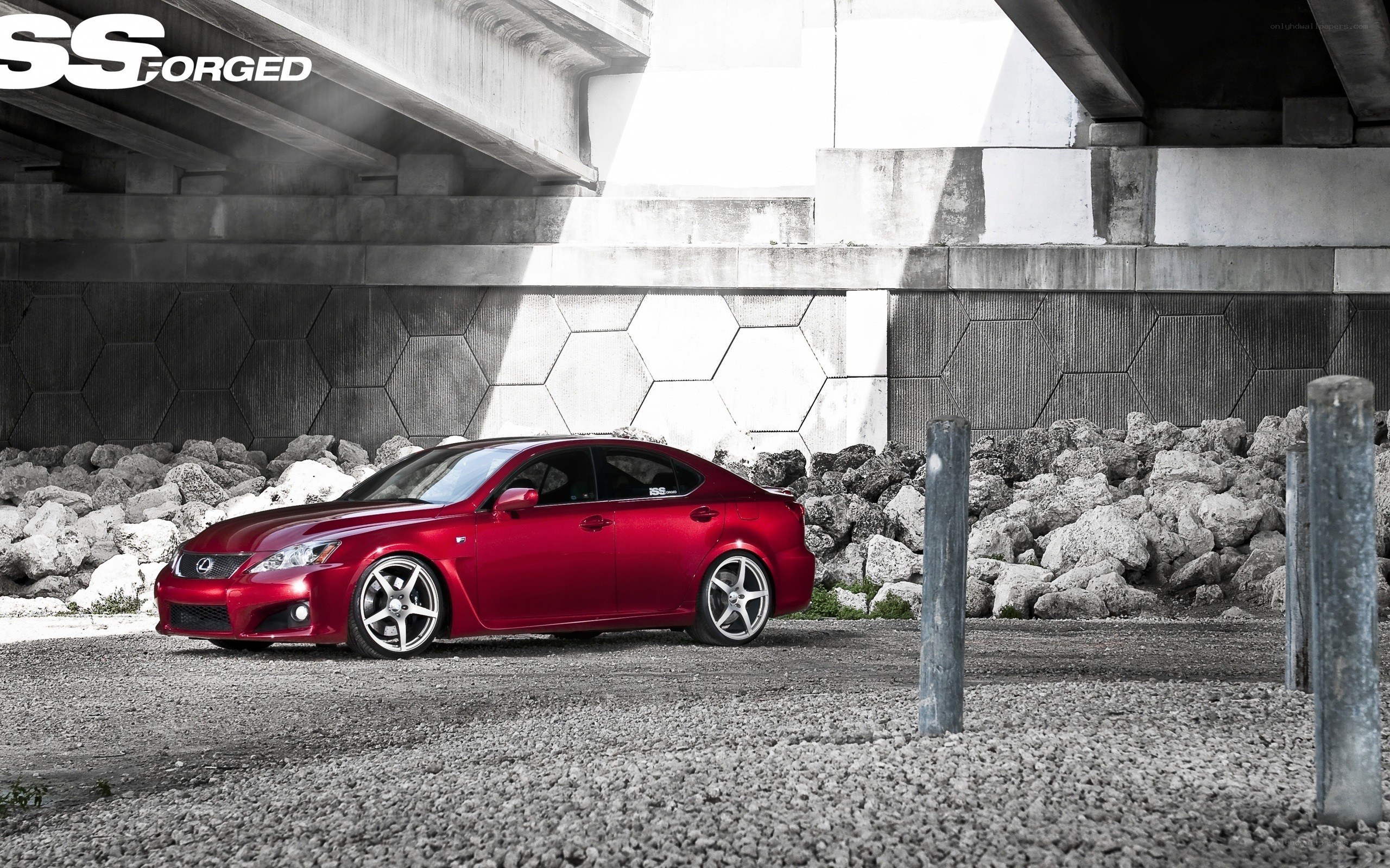 Red Lexus under a bridge