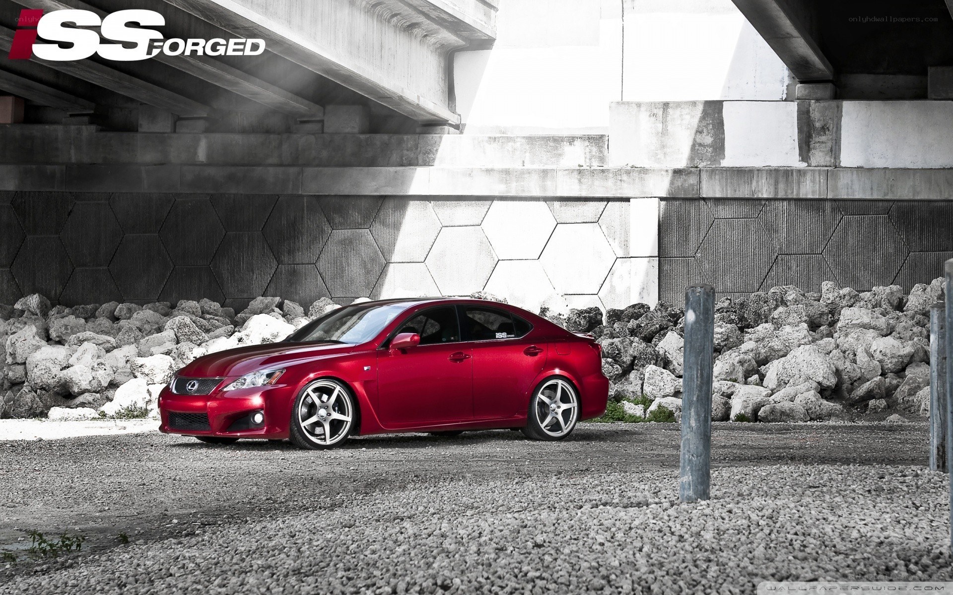 Red Lexus under a bridge