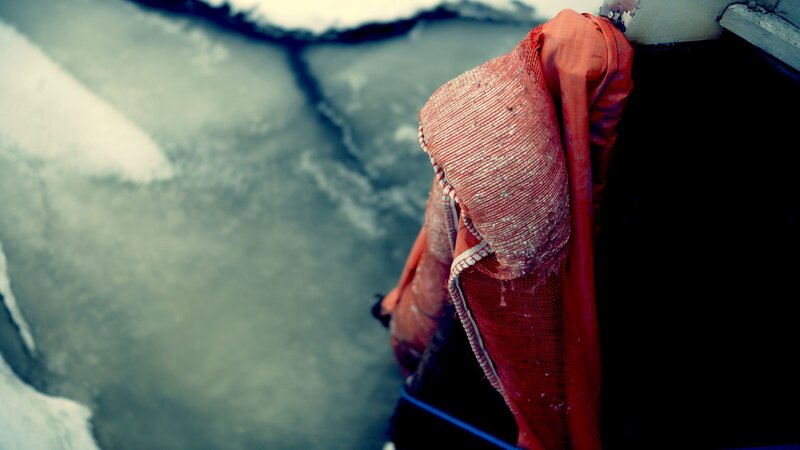 red life jacket on icy water