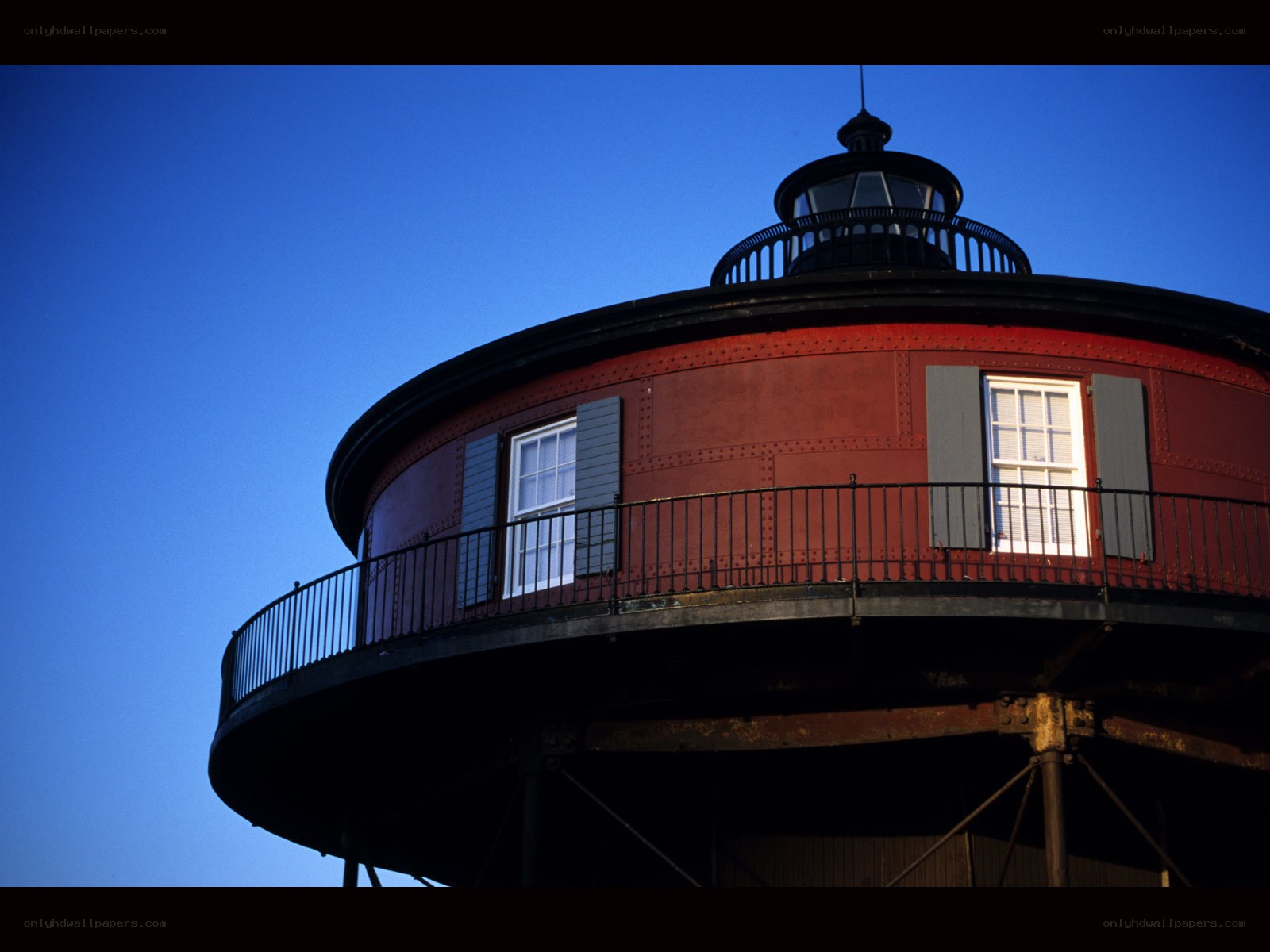 Red lighthouse against blue sky
