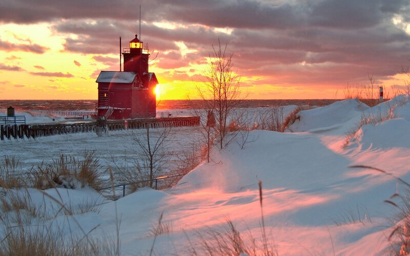 Red lighthouse at winter sunset