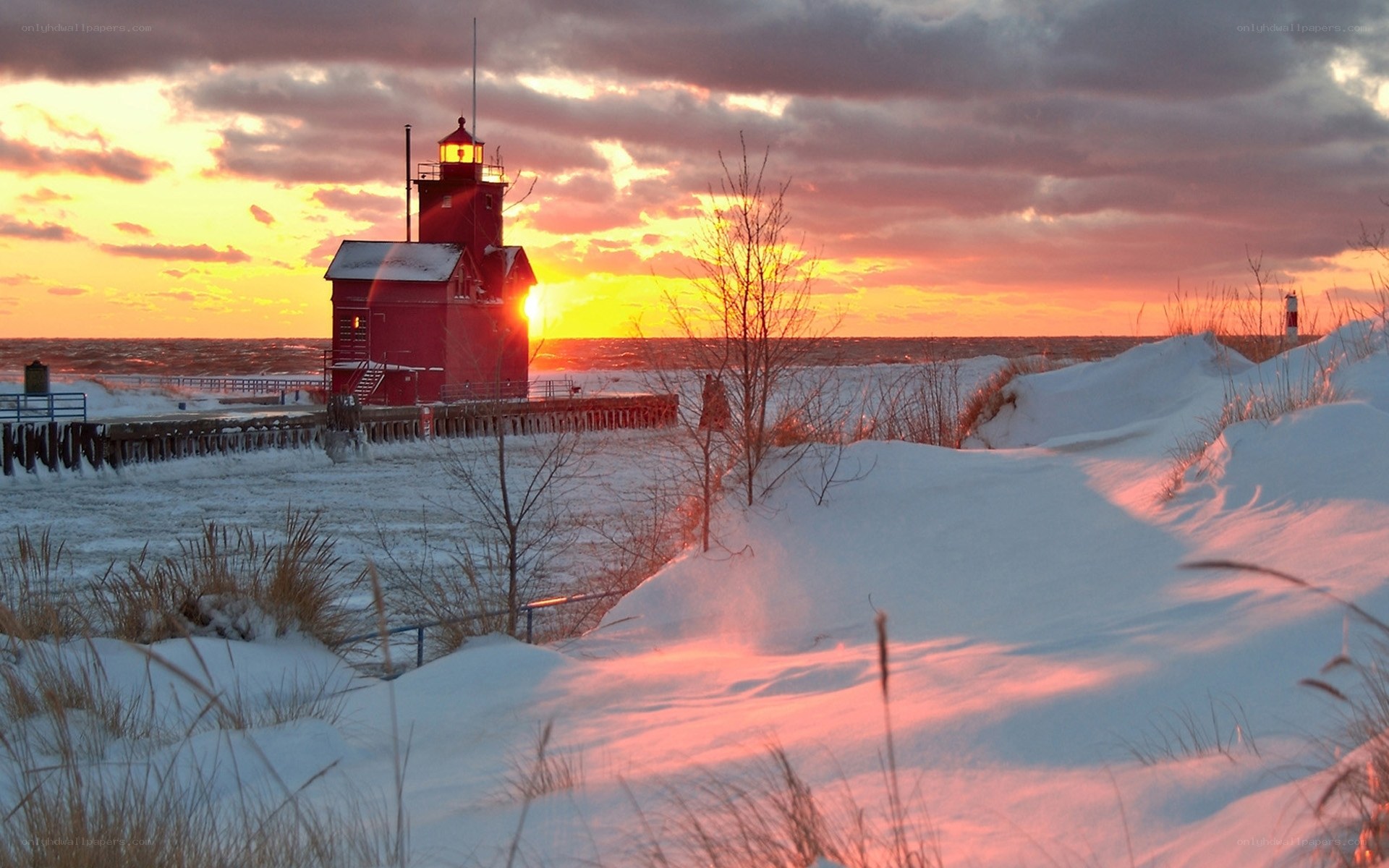 Red lighthouse at winter sunset