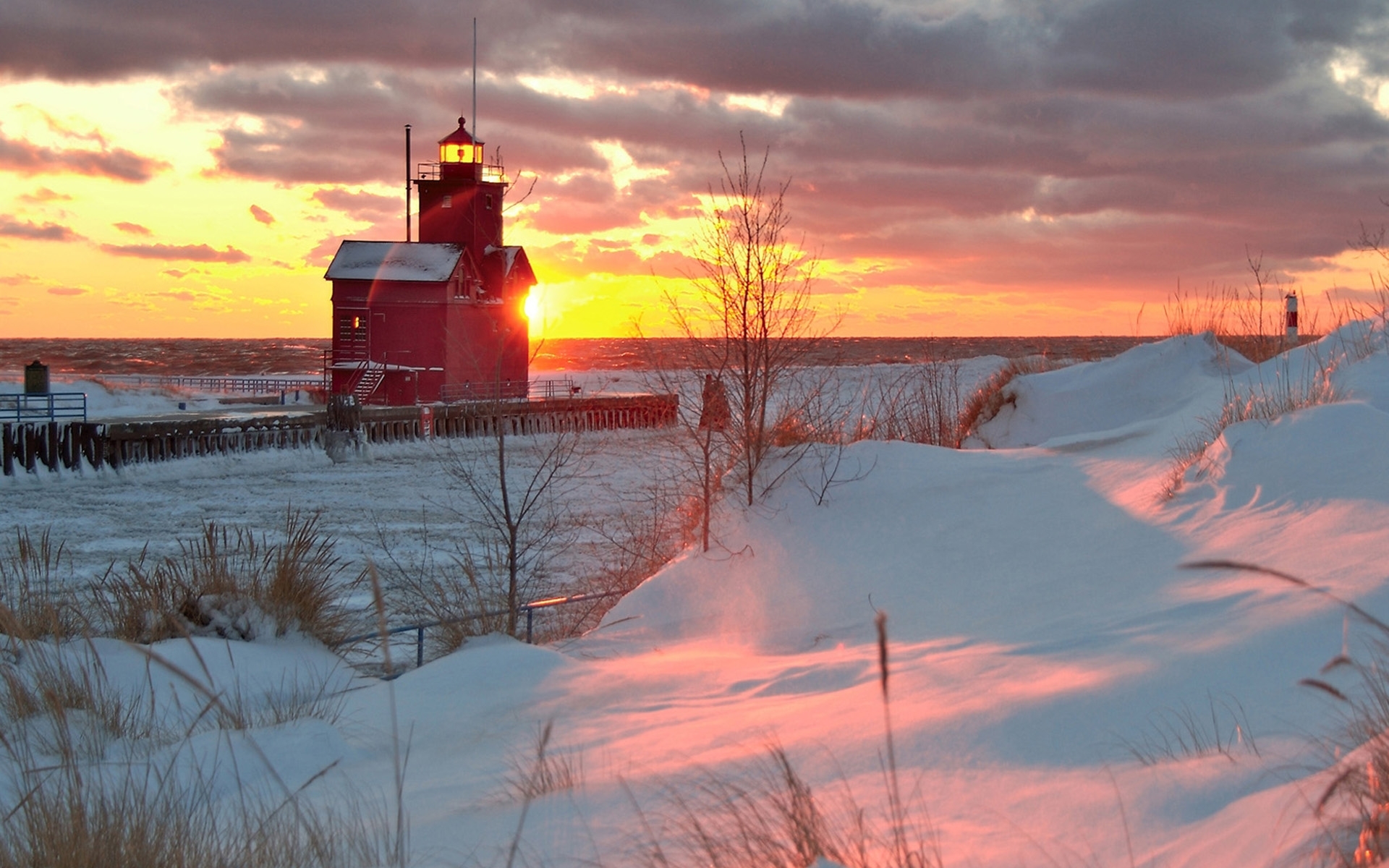 Red lighthouse at winter sunset