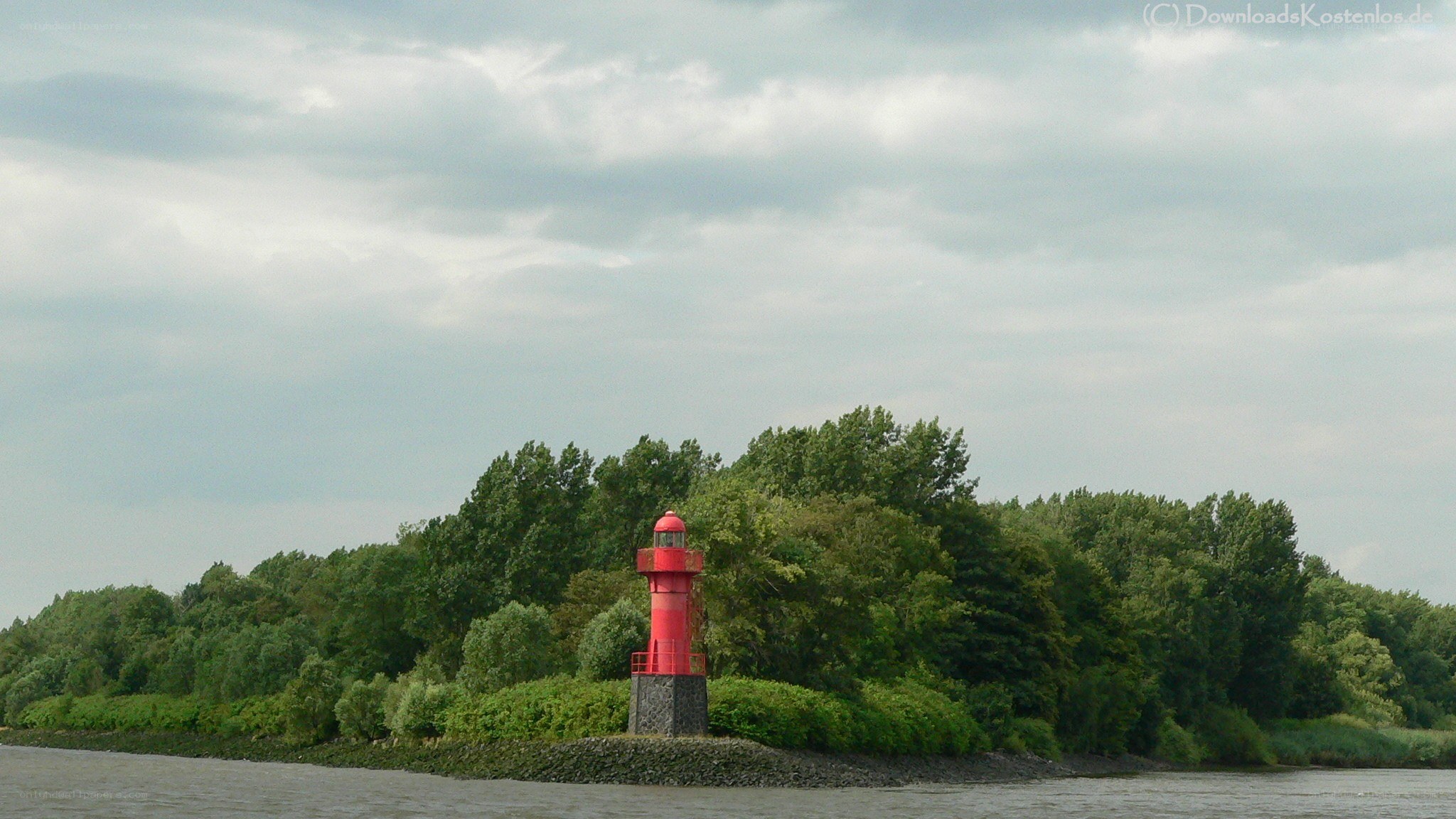 Red lighthouse on a river island
