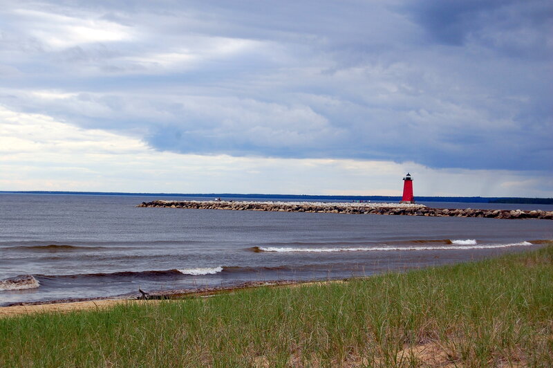 Red lighthouse on a rocky jetty