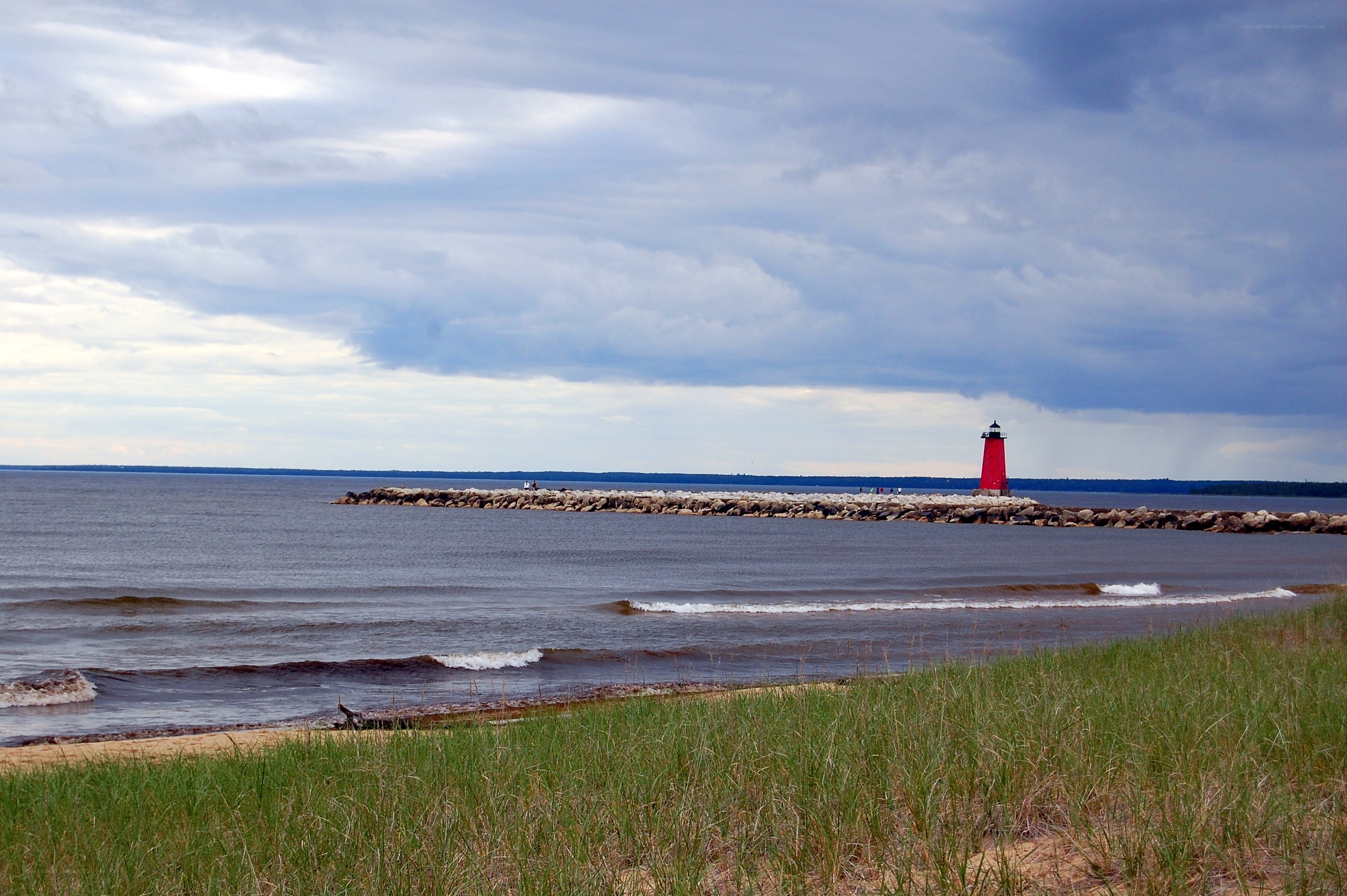 Red lighthouse on a rocky jetty