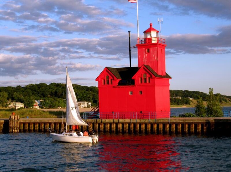Red lighthouse with sailboat