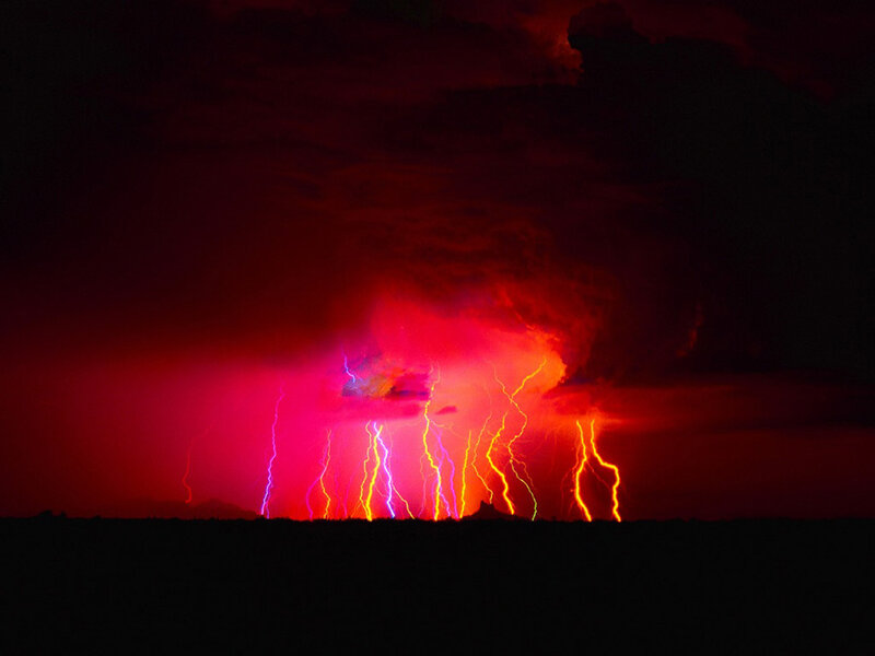 Red lightning storm at night